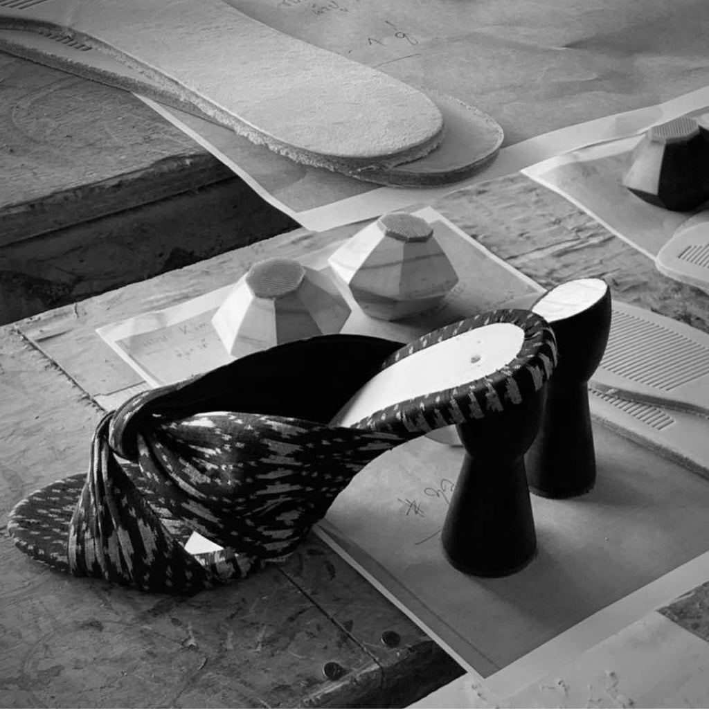 close up of shoemaking atelier with unfinished high heel shoes and carved wooden heels