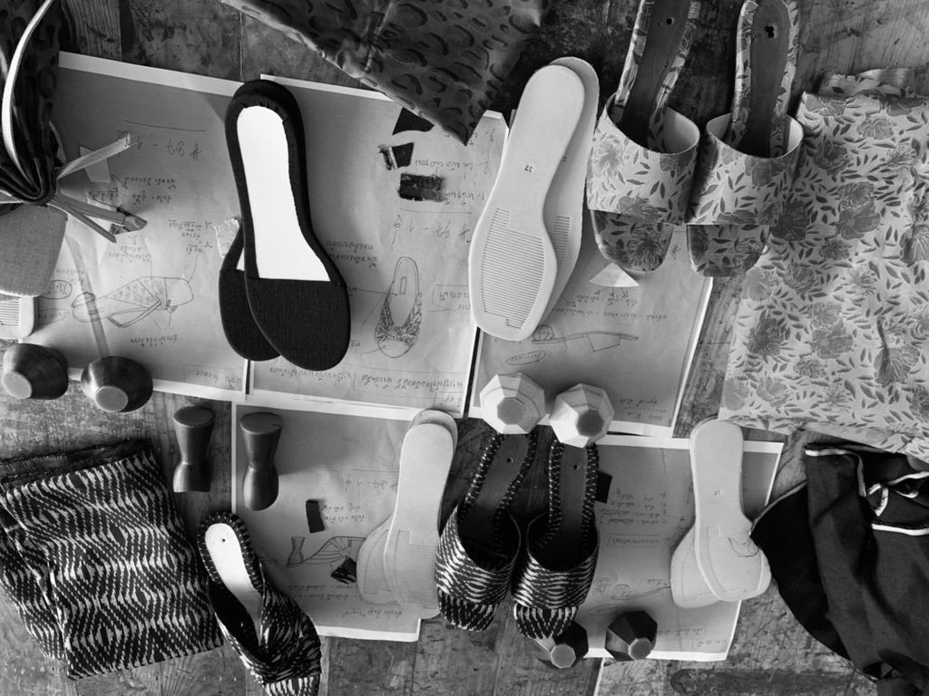 Sucette handcrafted designer shoe atelier workshop with shoe components, carved heels, and silk fabrics